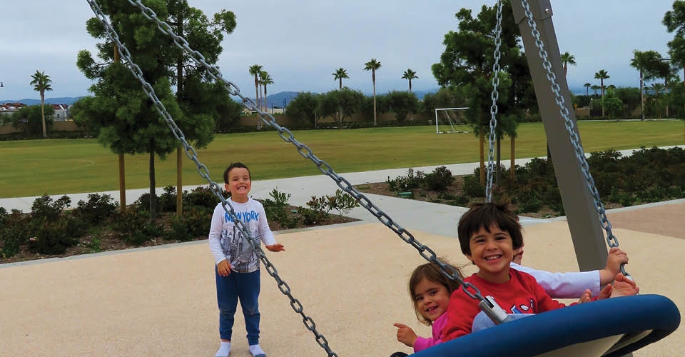 Children playing on a swing